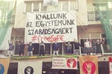 Former students are standing on the terrace and "guarding" the university (different actors every day, even the most famous ones). 