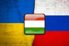 The Hungarian flag with the background of the flags of Ukraine and Russia