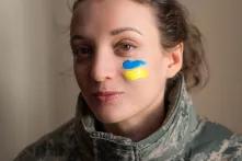 Indoor portrait of young girl with blue and yellow Ukrainian flag