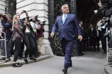 image of Viktor Orbán walking confidently among photographers