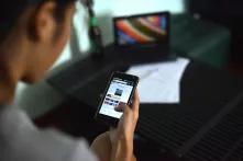 a woman reading an online news site on her smartphone