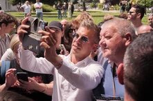 Peter Magyar takes a selfie with a man among the people. A political countrywide tour event by the Tisza Party. 2024