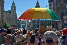 A crowd at Budapest Pride standing in front of Elisabeth Bridge in Budapest.
