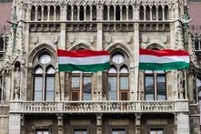 Detail of Parliament in Budapest, Hungary, with waving Hungarian flags