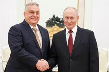 Russia's President Vladimir Putin (R) and Hungary's Prime Minister Viktor Orban shake hands during a meeting at the Moscow Kremlin