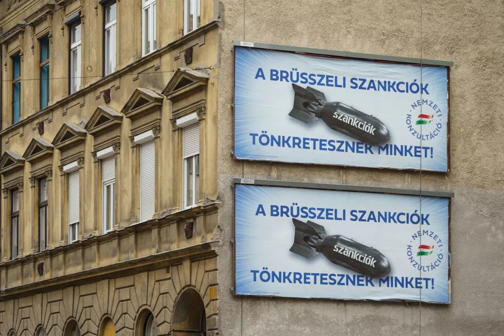 an image of two large billboards depicting a bomb labelled "sanctions" and the text "Brussel's sanctions are destroying us"