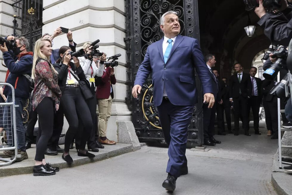 image of Viktor Orbán walking confidently among photographers