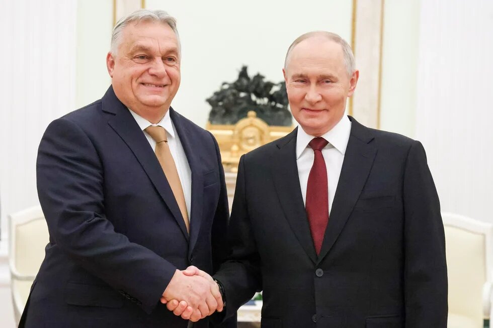 Russia's President Vladimir Putin (R) and Hungary's Prime Minister Viktor Orban shake hands during a meeting at the Moscow Kremlin