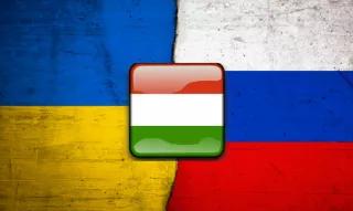 The Hungarian flag with the background of the flags of Ukraine and Russia