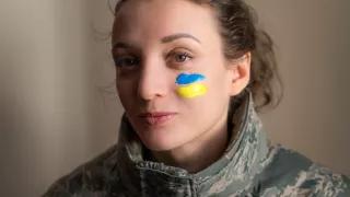 Indoor portrait of young girl with blue and yellow Ukrainian flag